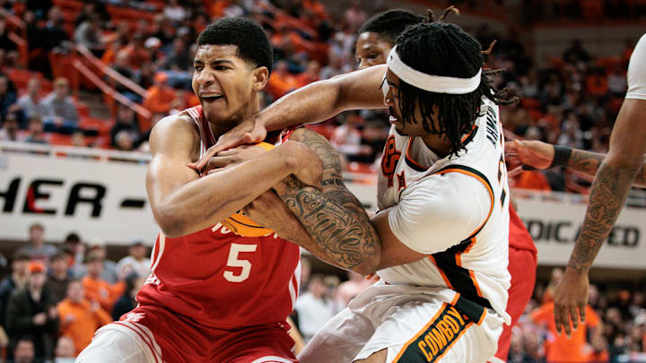 Mar 7, 2026; Stillwater, Oklahoma, USA;  Oklahoma State Cowboys center Benjamin Ahmed (23) and Houston Cougars forward Chris Cenac Jr. (5) struggle for the ball during the first half at Gallagher-Iba Arena. Mandatory Credit: William Purnell-Imagn Images