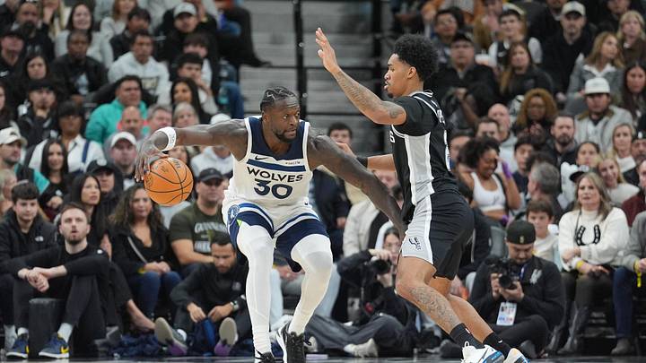 Jan 17, 2026; San Antonio, Texas, USA; Minnesota Timberwolves forward Julius Randle (30) dribbles against San Antonio Spurs guard Dylan Harper (2) in the second half at Frost Bank Center. Mandatory Credit: Daniel Dunn-Imagn Images