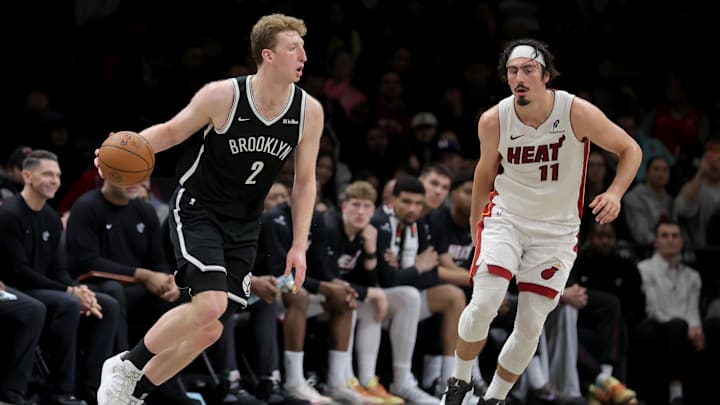 Dec 18, 2025; Brooklyn, New York, USA; Brooklyn Nets forward Danny Wolf (2) controls the ball against Miami Heat forward Jaime Jaquez Jr. (11) during the fourth quarter at Barclays Center. Mandatory Credit: Brad Penner-Imagn Images