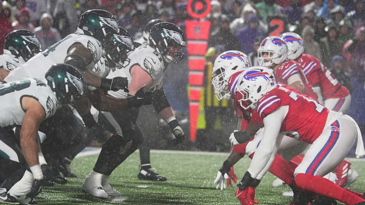 The Eagles' offensive line faces off against the Bills' defensive line with rain pouring down on them during second-half action against the Philadelphia Eagles at Highmark Stadium in Orchard Park on Dec. 28, 2025.