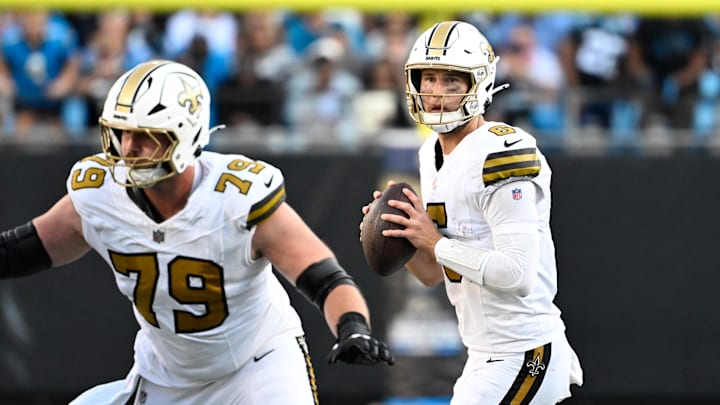 Nov 9, 2025; Charlotte, North Carolina, USA;  New Orleans Saints quarterback Tyler Shough (6) looks to pass as center Luke Fortner (79) blocks in the fourth quarter at Bank of America Stadium. Mandatory Credit: Bob Donnan-Imagn Images