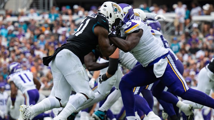 Nov 10, 2024; Jacksonville, Florida, USA; Jacksonville Jaguars defensive end Josh Hines-Allen (41) battles against Minnesota Vikings tackle Cam Robinson (74) in the second quarter at EverBank Stadium. Mandatory Credit: Jeremy Reper-Imagn Images