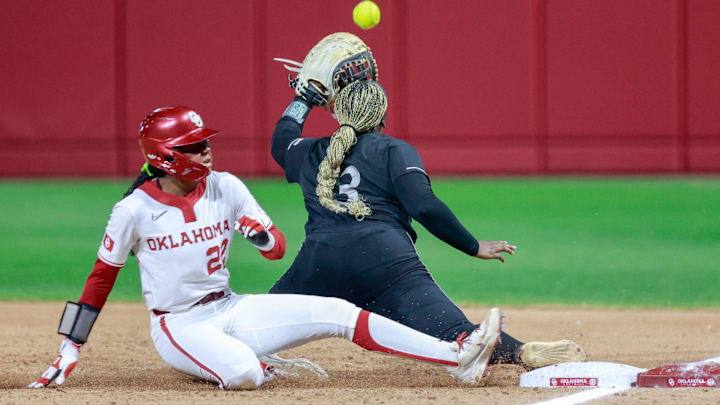 Alabama State first baseman Bailee Williams (13) forces out Oklahoma outfielder Kai Minor (22) at first base during the home opener between Oklahoma and Alabama State at Love’s Field in Norman Okla., on Thursday, Feb. 26, 2026. The speedy Minor is helping the Sooners' offense go early on.