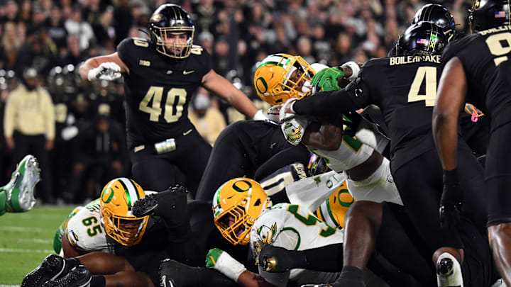 Oregon Ducks running back Jordan James (20) dives over the pile past Purdue Boilermakers Oregon Ducks running back Jordan James (20) dives over the pile past Purdue Boilermakers