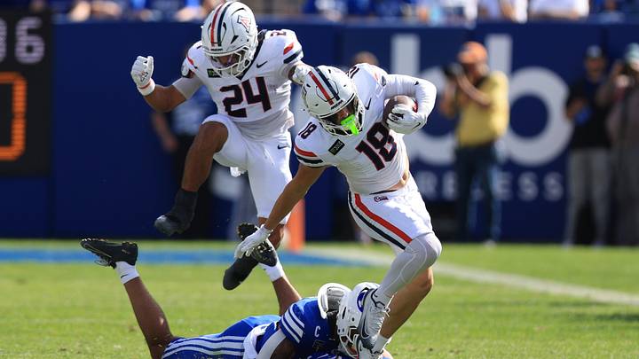Sep 12, 2026; Provo, Utah, USA;  Arizona Wildcats wide receiver Brandon Phelps (18) runs after a catch against BYU Cougars linebacker Isaiah Glasker (16) during the second half at LaVell Edwards Stadium.
