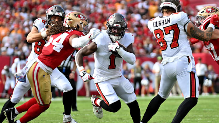 Oct 12, 2025; Tampa, Florida, USA; Tampa Bay Buccaneers running back Rachaad White (1) runs for a gain past San Francisco 49ers middle linebacker Fred Warner (54) during the first quarter at Raymond James Stadium. Mandatory Credit: Jonathan Dyer-Imagn Images Oct 12, 2025; Tampa, Florida, USA; Tampa Bay Buccaneers running back Rachaad White (1) runs for a gain past San Francisco 49ers middle linebacker Fred Warner (54) during the first quarter at Raymond James Stadium. Mandatory Credit: Jonathan Dyer-Imagn Images