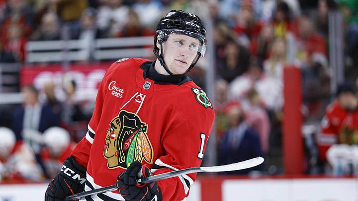 Nov 18, 2025; Chicago, Illinois, USA; Chicago Blackhawks center Oliver Moore (11) looks on during the second period of an NHL game against the Calgary Flames at United Center. Mandatory Credit: Kamil Krzaczynski-Imagn Images