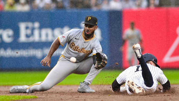Pittsburgh Pirates shortstop Liover Peguero (31) catches for a tag out on New York Yankees shortstop Anthony Volpe (11) during a steal attempt during the second inning at Yankee Stadium. 