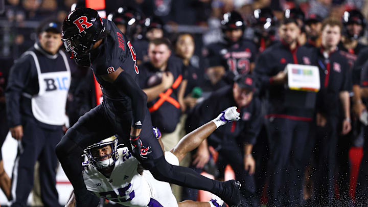 Sep 27, 2024; Piscataway, New Jersey, USA; Rutgers Scarlet Knights wide receiver KJ Duff (8) is tackled by Washington Huskies cornerback Elijah Jackson (25) during the first half at SHI Stadium. Mandatory Credit: Vincent Carchietta-Imagn Images