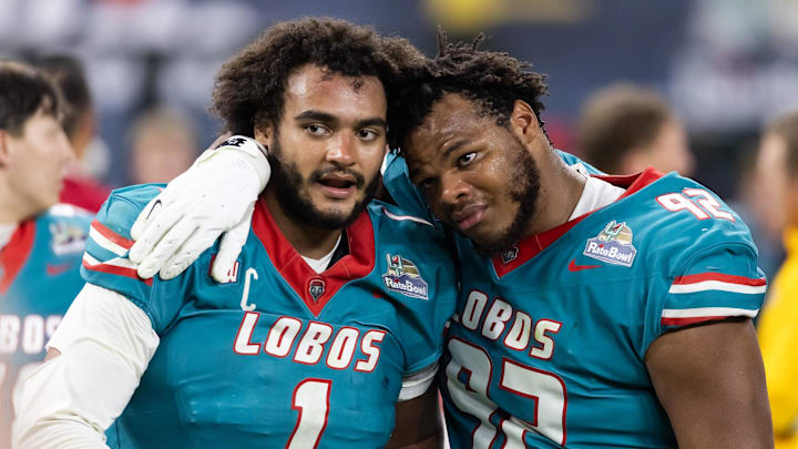 Dec 26, 2025; Phoenix, AZ, USA; New Mexico Lobos defensive end Keyshawn James-Newby (1) and defensive tackle Brian Booker (92) react as they walk off the field after losing in overtime to the Minnesota Gophers during the Rate Bowl at Chase Field. 