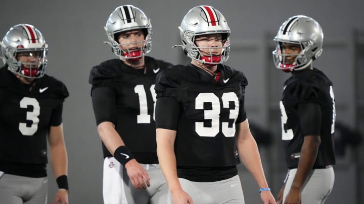 Mar 5, 2024; Columbus, OH, USA; Ohio State Buckeyes quarterback Devin Brown (33) lines up ahead of quarterbacks Air Noland (12), Will Howard (18) and Lincoln Kienholz (3) during the first spring practice at the Woody Hayes Athletic Center.