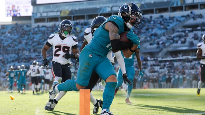 Dec 1, 2024; Jacksonville, Florida, USA; Jacksonville Jaguars wide receiver Parker Washington (11) scores a touchdown against the Houston Texans in the fourth quarter at EverBank Stadium. Mandatory Credit: Nathan Ray Seebeck-Imagn Images