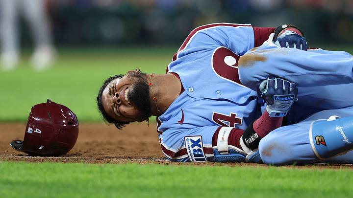Philadelphia, Pennsylvania, USA; Philadelphia Phillies second baseman Luis Arraez (4) grabs his leg with an apparent injury while running to first base during the sixth inning against the Milwaukee Brewers at Citizens Bank Park. Mandatory Credit: Bill Streicher-Imagn Images
