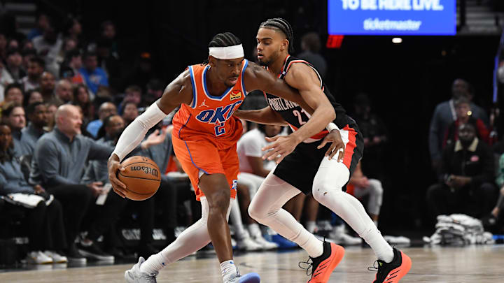 Nov 1, 2024; Portland, Oregon, USA; Portland Trailblazers guard/forward Ryan Rupert (21) defends against Oklahoma City Thunder guard Shai Gilgeous-Alexander (2) during the third quarter at Moda Center. Mandatory Credit: Brian Murphy-Imagn Images