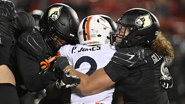 Nov 9, 2023; Louisville, Kentucky, USA; Louisville Cardinals defensive lineman Ashton Gillotte (9) tackles Virginia Cavaliers running back Perris Jones (2) during the second half at L&N Federal Credit Union Stadium. Louisville defeated Virginia 31-24. Nov 9, 2023; Louisville, Kentucky, USA; Louisville Cardinals defensive lineman Ashton Gillotte (9) tackles Virginia Cavaliers running back Perris Jones (2) during the second half at L&N Federal Credit Union Stadium. Louisville defeated Virginia 31-24.
