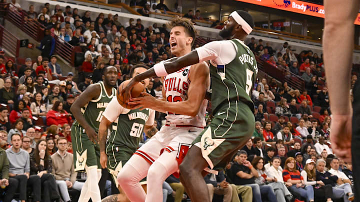 Oct 12, 2025; Chicago, Illinois, USA;  Chicago Bulls forward/center Zach Collins (12) and Milwaukee Bucks forward Bobby Portis (9) fight for the ball during the first half at the United Center. Mandatory Credit: Matt Marton-Imagn Images