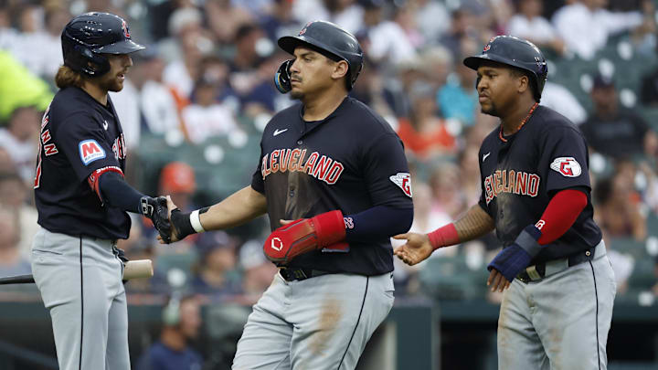 Jul 9, 2024; Detroit, Michigan, USA;  Cleveland Guardians third base José Ramírez (11) and first base Josh Naylor (22) receive congratulations from shortstop Daniel Schneemann (10) after scoring in the third inning against the Detroit Tigers at Comerica Park. Mandatory Credit: Rick Osentoski-Imagn Images