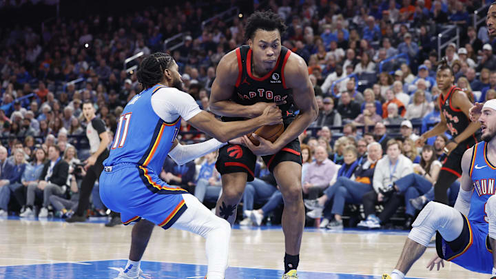 Feb 7, 2025; Oklahoma City, Oklahoma, USA; Toronto Raptors forward Scottie Barnes (4) is defended by Oklahoma City Thunder guard Isaiah Joe (11) on a drive to the basket during the second half at Paycom Center. Mandatory Credit: Alonzo Adams-Imagn Images