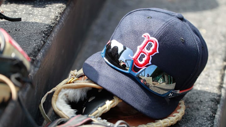 Mar 7, 2015; Sarasota, FL, USA; A general view of  Boston Red Sox hat and glove laying in the dugout at a spring training baseball game at Ed Smith Stadium. Mandatory Credit: Kim Klement-Imagn Images