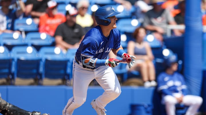 Dunedin, Florida, USA; Toronto Blue Jays outfielder Daulton Varsho (5) hits an RBI single against the Baltimore Orioles in the first inning during spring training at TD Ballpark.