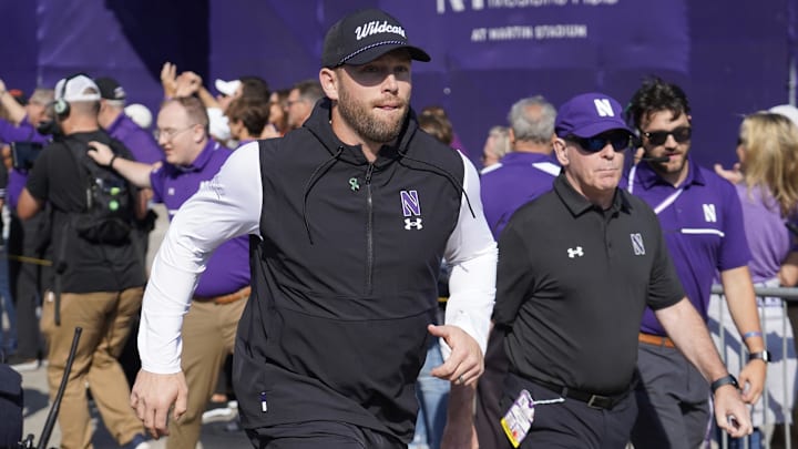 Oct 5, 2024; Evanston, Illinois, USA; Northwestern Wildcats head coach David Braun takes the field against the Indiana Hoosiers at Lanny and Sharon Martin Stadium. Mandatory Credit: David Banks-Imagn Images Oct 5, 2024; Evanston, Illinois, USA; Northwestern Wildcats head coach David Braun takes the field against the Indiana Hoosiers at Lanny and Sharon Martin Stadium. Mandatory Credit: David Banks-Imagn Images