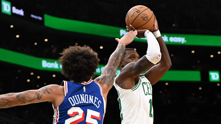 Oct 12, 2024; Boston, Massachusetts, USA; Boston Celtics guard Lonnie Walker IV (12) attempts a basket in front of Philadelphia 76ers guard Lester Quinones (25) during the second half at the TD Garden. Mandatory Credit: Brian Fluharty-Imagn Images