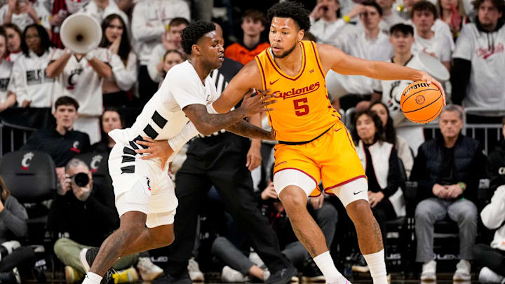 Cincinnati Bearcats guard Jizzle James (2) guards Iowa State Cyclones forward Joshua Jefferson (5) in the first half of the NCAA Big 12 basketball game between the Cincinnati Bearcats and the Iowa State Cyclones at Fifth Third Stadium in Cincinnati on Saturday, Jan. 17, 2026.