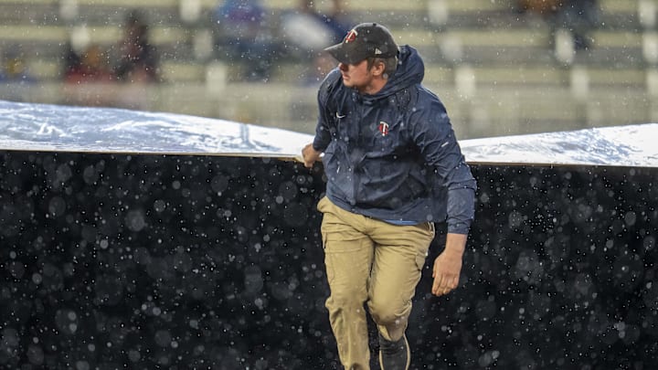 May 19, 2025; Minneapolis, Minnesota, USA; Minnesota Twins grounds crew roll out the on field tarp during the second inning in a game between the Cleveland Guardians and Minnesota Twins at Target Field. Mandatory Credit: Jesse Johnson-Imagn Images