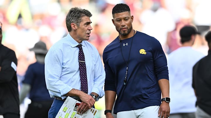 Aug 31, 2024; College Station, Texas, USA; Chris Fowler a broadcaster for ESPN, left, speaks with Notre Dame Fighting Irish head coach Marcus Freeman prior to the game against the Texas A&M Aggies at Kyle Field. Mandatory Credit: Maria Lysaker-Imagn Images