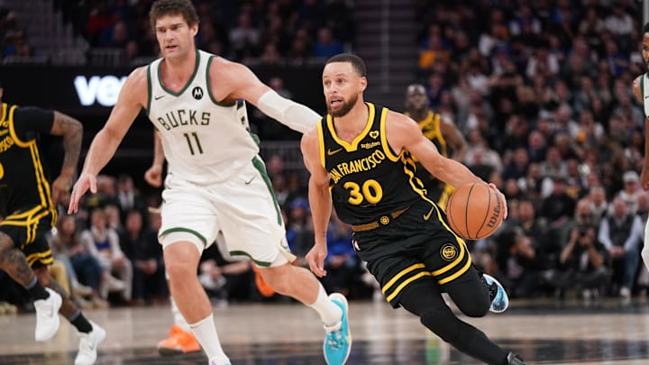 Mar 6, 2024; San Francisco, California, USA; Golden State Warriors guard Stephen Curry (30) dribbles past Milwaukee Bucks center Brook Lopez (11) in the third quarter at the Chase Center. Mandatory Credit: Cary Edmondson-Imagn Images