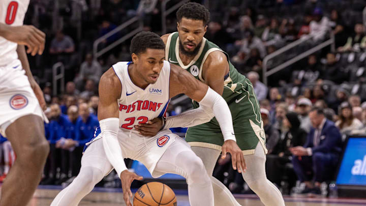 Jan 22, 2024; Detroit, Michigan, USA; Detroit Pistons guard Jaden Ivey (23) protects the ball from Milwaukee Bucks guard Malik Beasley (5) during the first quarter at Little Caesars Arena. Mandatory Credit: David Reginek-Imagn Images