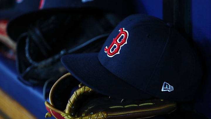 Jul 22, 2019; St. Petersburg, FL, USA; A detail view of Boston Red Sox hat and glove laying in the dugout at Tropicana Field. Mandatory Credit: Kim Klement-Imagn Images
