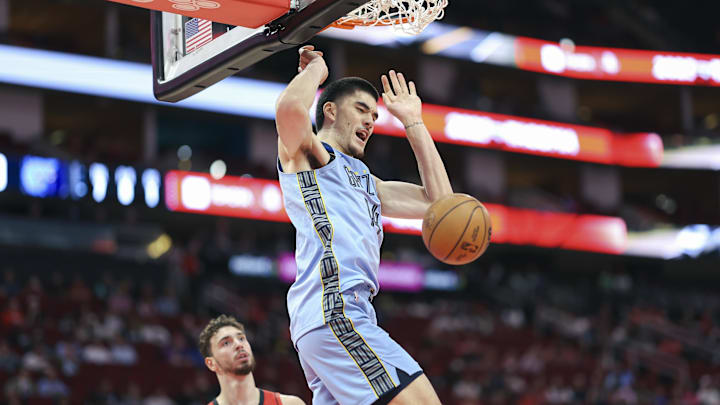 Memphis Grizzlies center Zach Edey (14) dunks the ball 