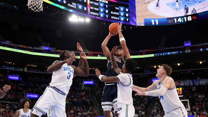 Nov 14, 2025; Inglewood, California, USA;  Arizona Wildcats forward Koa Peat (10) shoots the ball over UCLA Bruins forward Eric Dailey Jr. (3) during the first half of the Hall of Fame Series game at Intuit Dome. Mandatory Credit: Kiyoshi Mio-Imagn Images