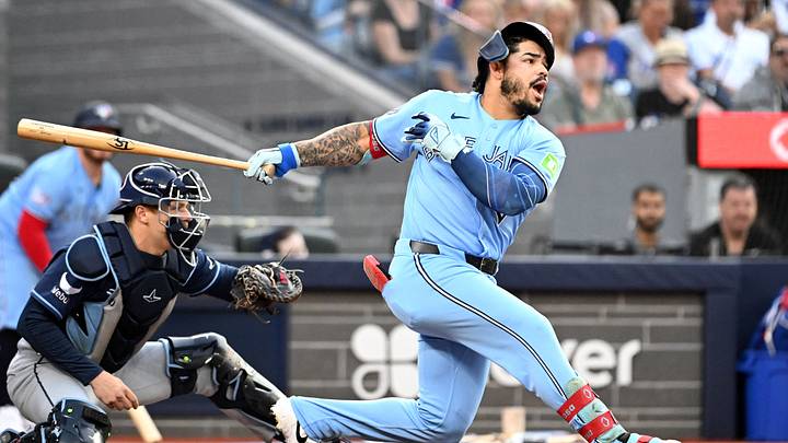 Jul 22, 2026; Toronto, Ontario, CAN;   Toronto Blue Jays left fielder Yohendrick Pinango (24) dislodges his batting helmet as he strikes out swinging against the Tampa Bay Rays in the first inning at Rogers Centre. Mandatory Credit: Dan Hamilton-Imagn Images
