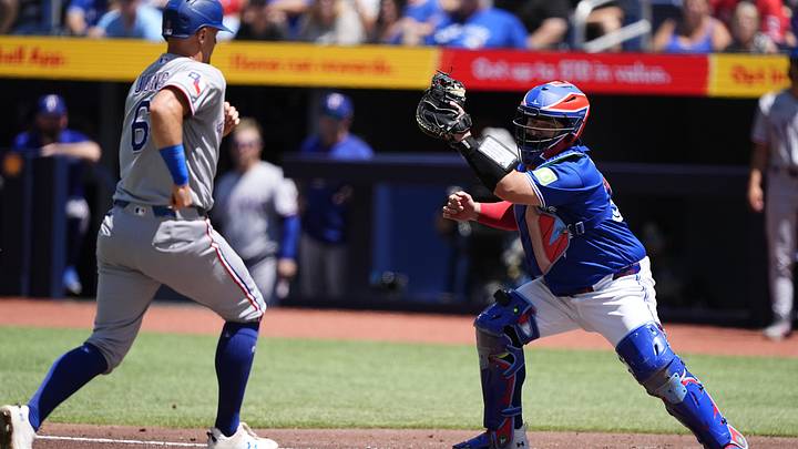 Jun 28, 2026; Toronto, Ontario, CAN; Toronto Blue Jays catcher Alejandro Kirk (30) gets Texas Rangers third baseman Josh Jung (6) out on a force play at home plate during the first inning at Rogers Centre. Mandatory Credit: John E. Sokolowski-Imagn Images