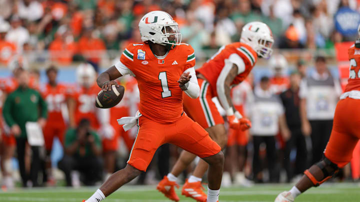 Dec 28, 2024; Orlando, FL, USA; Miami Hurricanes quarterback Cam Ward (1) drops back to pass against the Iowa State Cyclones in the first quarter during the Pop Tarts bowl at Camping World Stadium. Mandatory Credit: Nathan Ray Seebeck-Imagn Images