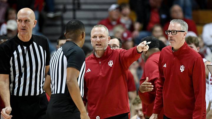 Dec 22, 2025; Bloomington, Indiana, USA; Indiana Hoosiers head coach Darian Devries talks to a referee during the second half against the Siena Saints at Simon Skjodt Assembly Hall. Mandatory Credit: Robert Goddin-Imagn Images