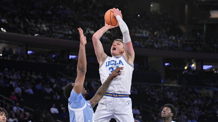 Dec 21, 2024; New York, NY, USA; UCLA Bruins forward Tyler Bilodeau (34) shoots the ball while being defended by North Carolina Tar Heels forward Ty Claude (0) during the first half at Madison Square Garden. Mandatory Credit: John Jones-Imagn Images