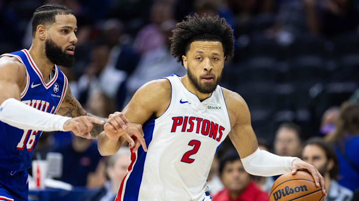 Oct 30, 2024; Philadelphia, Pennsylvania, USA; Detroit Pistons guard Cade Cunningham (2) drives past Philadelphia 76ers forward Caleb Martin (16) during the first quarter at Wells Fargo Center. Mandatory Credit: Bill Streicher-Imagn Images
