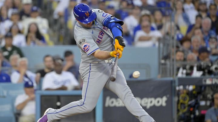Oct 20, 2024; Los Angeles, California, USA; New York Mets first baseman Pete Alonso (20) hits a single in the third inning against the Los Angeles Dodgers during game six of the NLCS for the 2024 MLB playoffs at Dodger Stadium. Mandatory Credit: Jayne Kamin-Oncea-Imagn Images