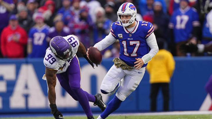 Nov 13, 2022; Orchard Park, New York, USA; Buffalo Bills quarterback Josh Allen (17) runs with the ball against Minnesota Vikings outside linebacker Danielle Hunter (99) during the second half at Highmark Stadium. 