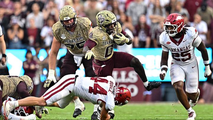 Oct 3, 2026; College Station, Texas, USA; Texas A&M Aggies running back KJ Edwards (0) runs the ball as Arkansas Razorbacks linebacker Ben Bogle (44) attempts a tackle during the first half at Kyle Field. Mandatory Credit: Maria Lysaker-Imagn Images Oct 3, 2026; College Station, Texas, USA; Texas A&M Aggies running back KJ Edwards (0) runs the ball as Arkansas Razorbacks linebacker Ben Bogle (44) attempts a tackle during the first half at Kyle Field. Mandatory Credit: Maria Lysaker-Imagn Images