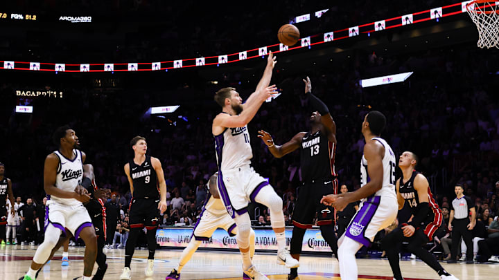 Nov 4, 2024; Miami, Florida, USA; Sacramento Kings forward Domantas Sabonis (11) shoots the game-winning basket over Miami Heat center Bam Adebayo (13) during the fourth quarter at Kaseya Center. Mandatory Credit: Sam Navarro-Imagn Images