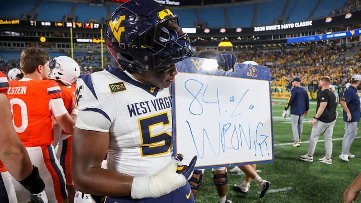 Sep 19, 2026; Charlotte, North Carolina, USA; West Virginia Mountaineers defensive lineman Taylor Brown (51) holds a sign as he celebrates after defeating the Virginia Cavaliers at Bank of America Stadium. Mandatory Credit: Ben Queen-Imagn Images Sep 19, 2026; Charlotte, North Carolina, USA; West Virginia Mountaineers defensive lineman Taylor Brown (51) holds a sign as he celebrates after defeating the Virginia Cavaliers at Bank of America Stadium. Mandatory Credit: Ben Queen-Imagn Images
