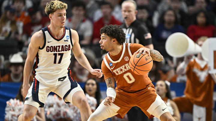 Texas Longhorns guard Jordan Pope dribbles against Gonzaga Bulldogs guard Mario Saint-Supery in the second half during a second round game of the men's 2026 NCAA Tournament at Moda Center. 