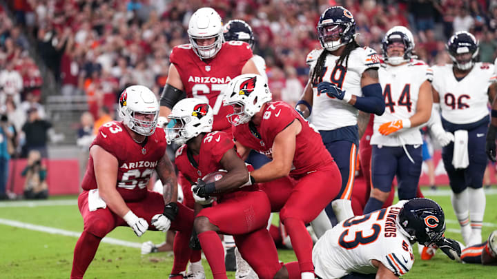 Nov 3, 2024; Glendale, Arizona, USA; Arizona Cardinals running back Trey Benson (33) celebrates a touchdown against the Chicago Bears during the first half at State Farm Stadium. Mandatory Credit: Joe Camporeale-Imagn Images