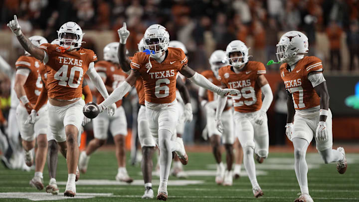 Texas Longhorns defensive back Kobe Black and teammates react after an interception during the second half against the Texas A&M Aggies at Darrell K Royal-Texas Memorial Stadium.