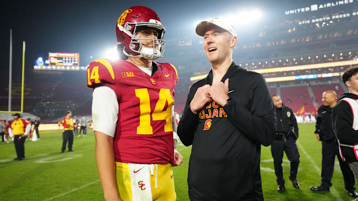 Nov 29, 2025; Los Angeles, California, USA; Southern California Trojans quarterback Jayden Maiava (14) and head coach Lincoln Riley react after the game against the UCLA Bruins at United Airlines Field at Los Angeles Memorial Coliseum. Mandatory Credit: Kirby Lee-Imagn Images Nov 29, 2025; Los Angeles, California, USA; Southern California Trojans quarterback Jayden Maiava (14) and head coach Lincoln Riley react after the game against the UCLA Bruins at United Airlines Field at Los Angeles Memorial Coliseum. Mandatory Credit: Kirby Lee-Imagn Images