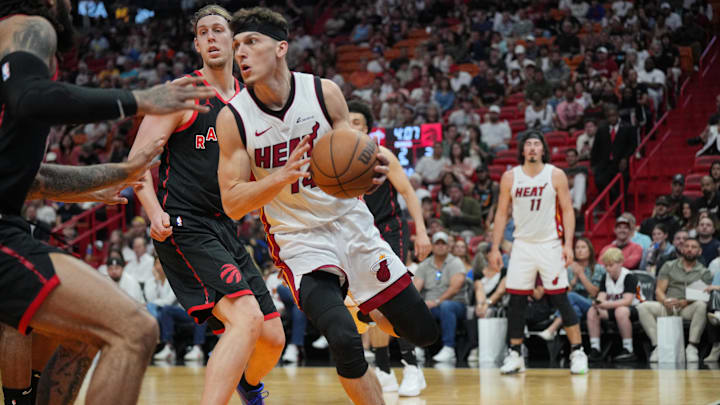 Apr 14, 2024; Miami, Florida, USA;  Miami Heat guard Tyler Herro (14) drives under the basket against the Toronto Raptors during the first half at Kaseya Center. Mandatory Credit: Jim Rassol-Imagn Images